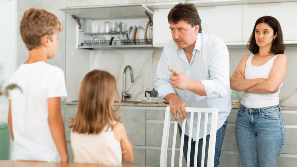 A man talking to a young boy in a living room