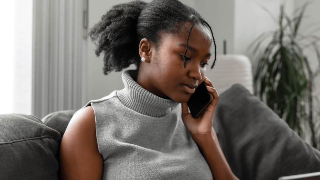 A person sitting on a couch looking at their phone