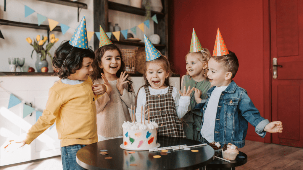 children celebrating their birthday with a cake