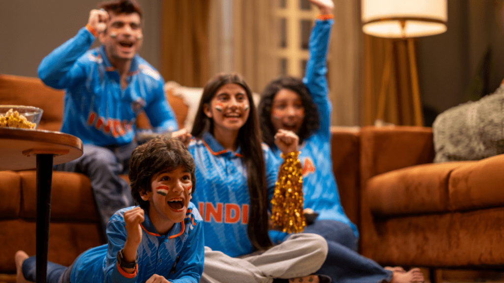 A family sitting on the couch watching TV