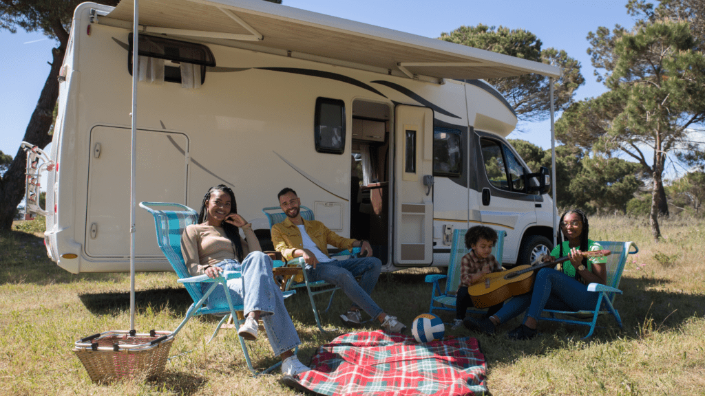 a group of people sitting in front of an rv