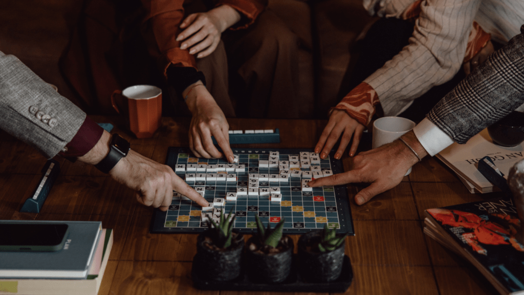 Four people sitting around a table playing a board game