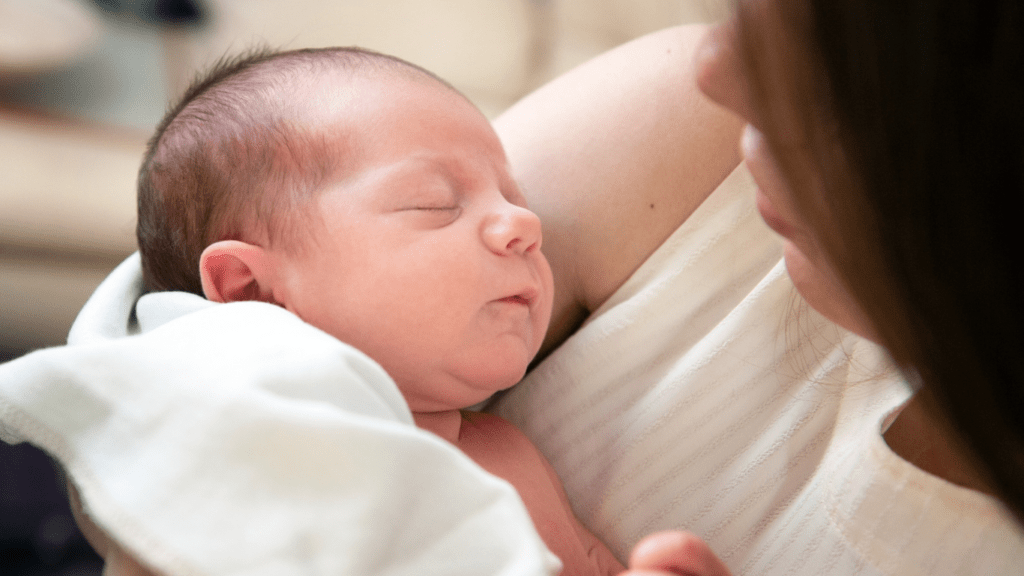 a person holding a baby in their arms