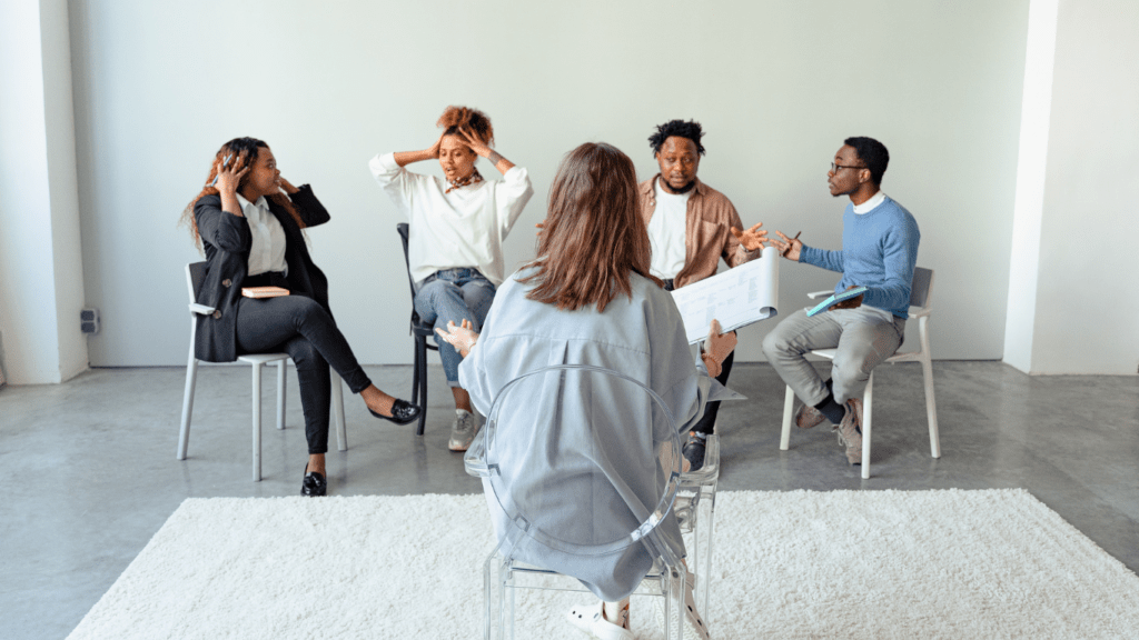 a group of people sitting on chairs in an office