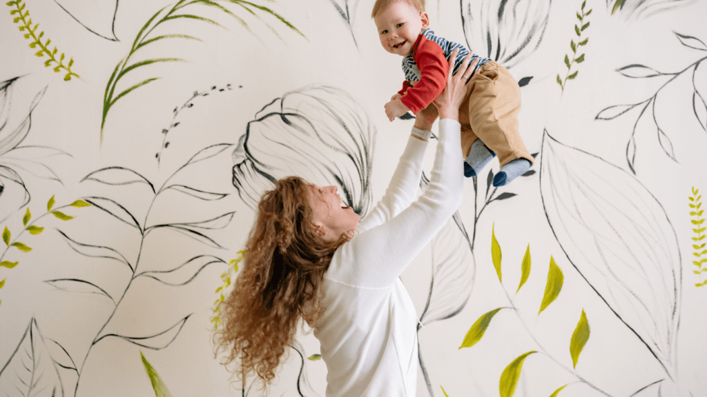 Someone holding up a toddler in the air