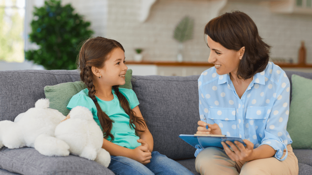 a person is sitting on a couch with a child