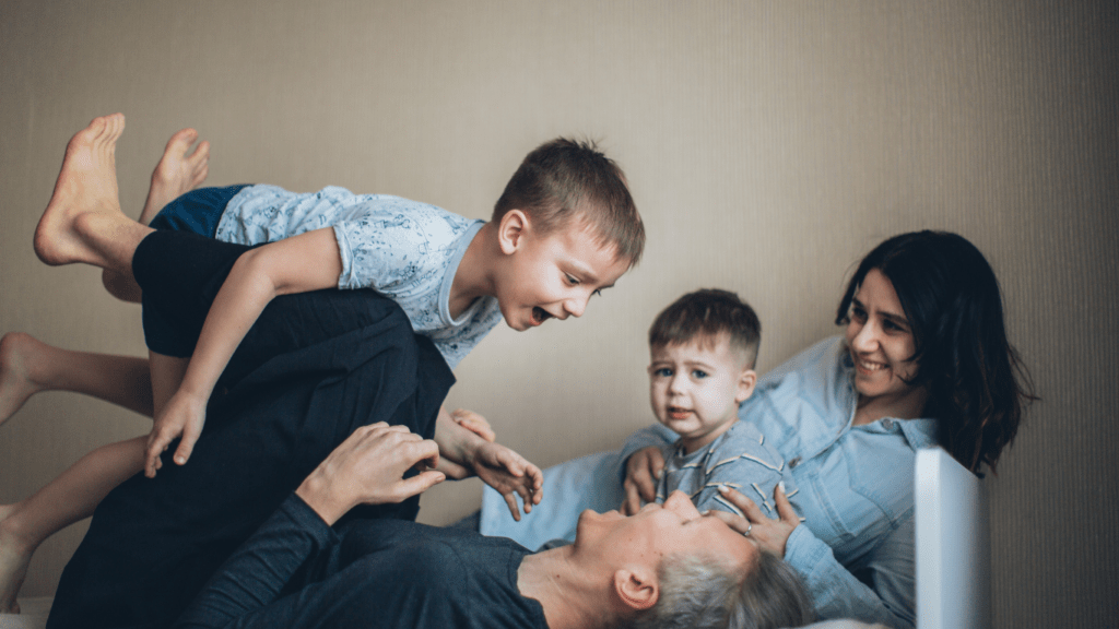 an image of a family playing on a bed