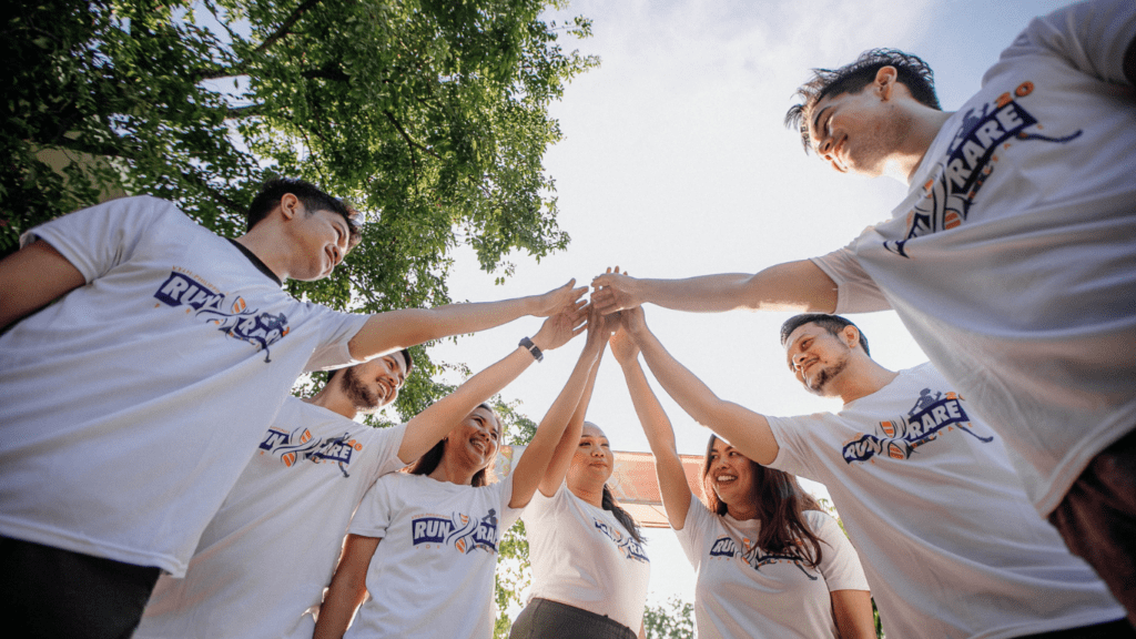 a group of people holding hands in the air