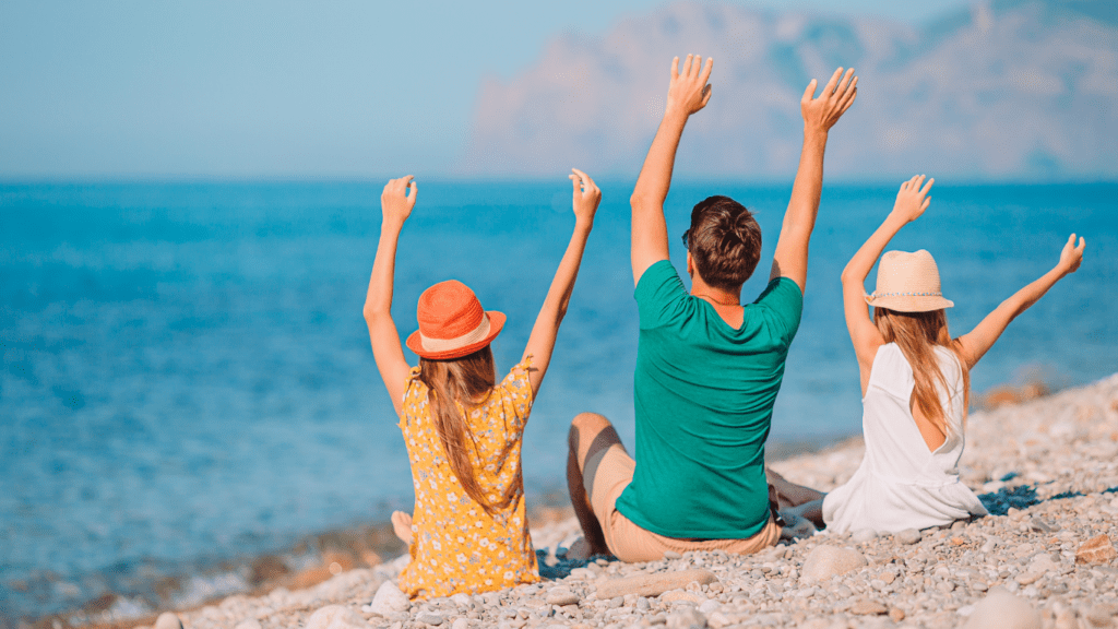 a family sitting on the beach