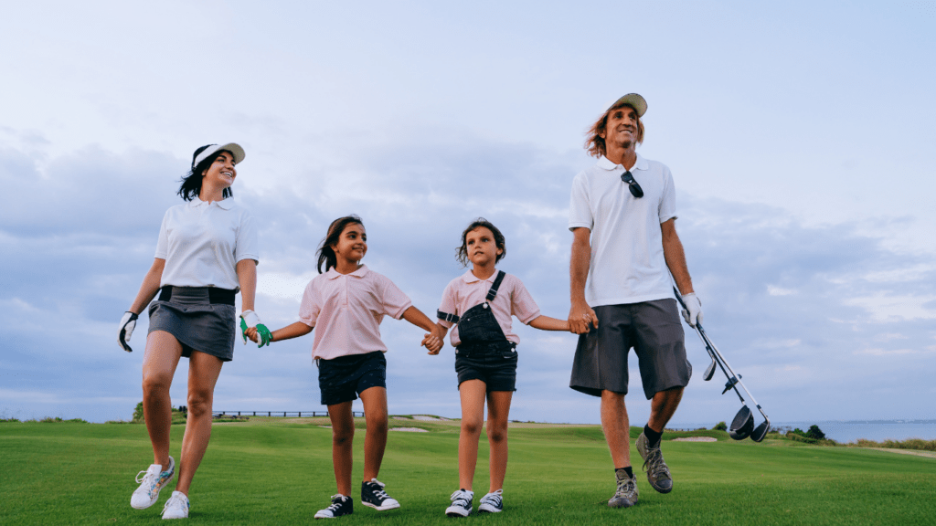 a group of children walking on a golf course