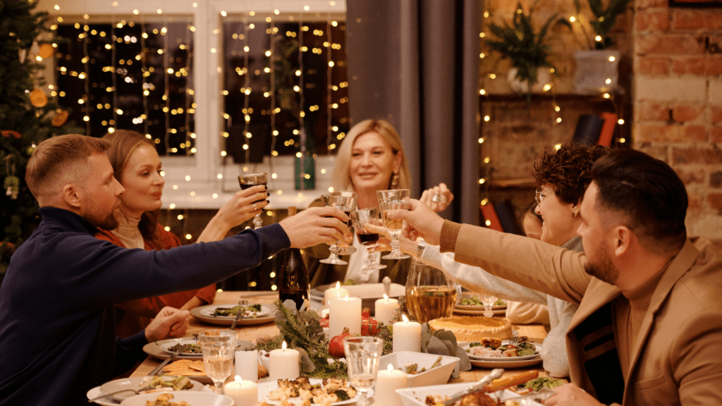 a group of people at a dinner table toasting wine