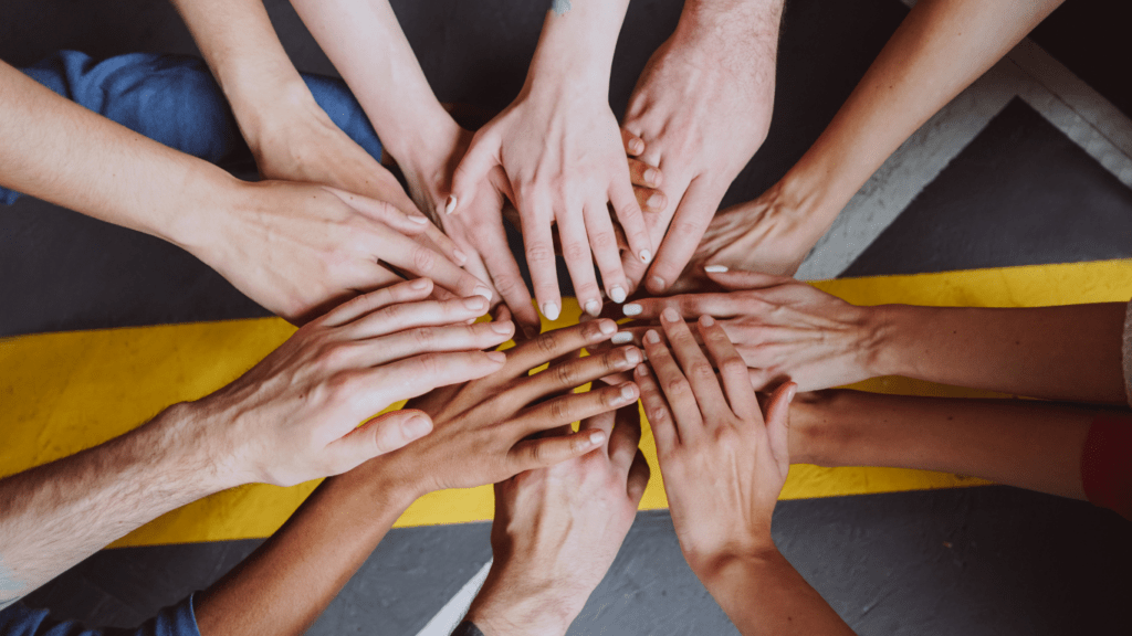 a group of people holding hands in the air