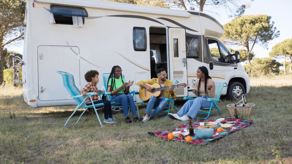 a group of people sitting in front of an rv