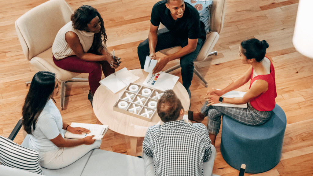 a group of people sitting on chairs in an office