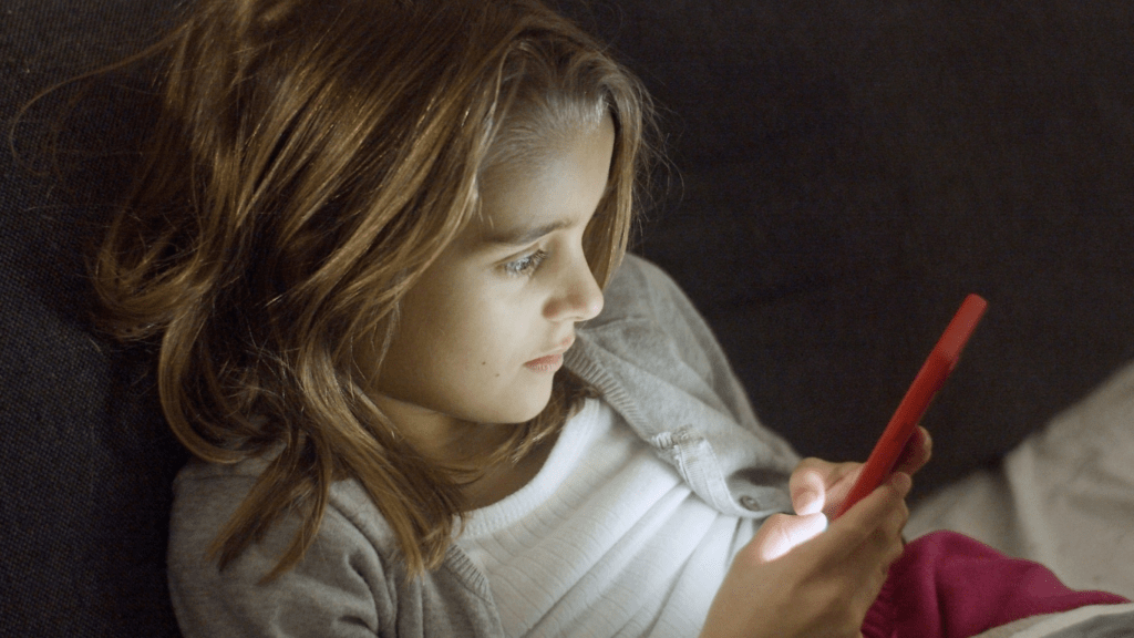 a person is sitting on a couch playing a video game