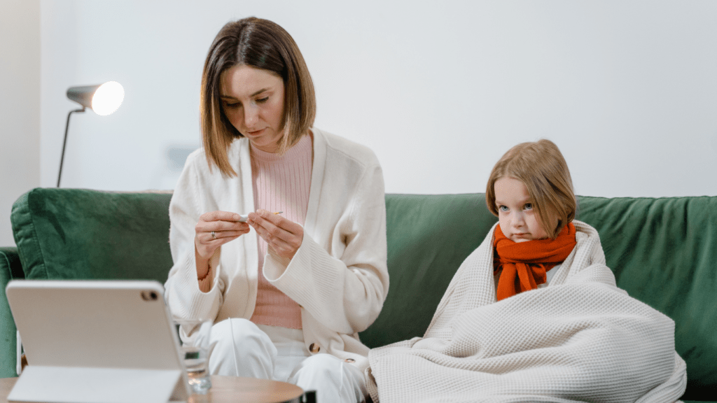 a person is sitting on a couch with a child