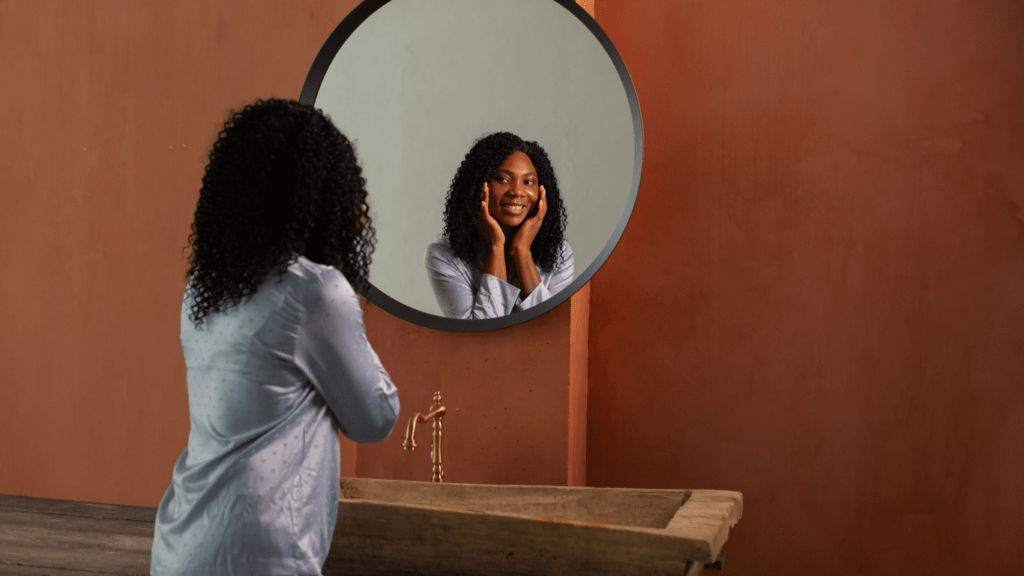 a person smiling in front of a mirror