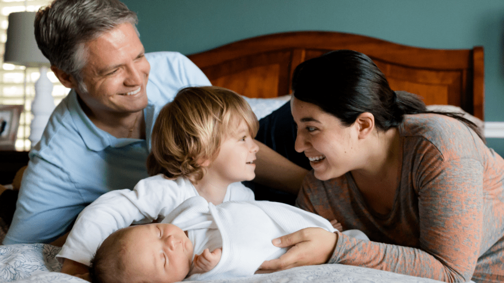 an image of a family playing on a bed