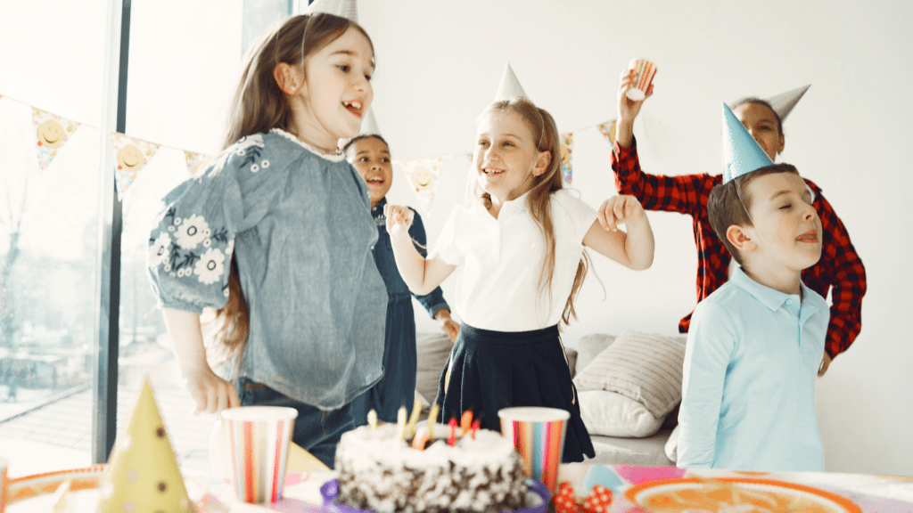 children celebrating their birthday with a cake