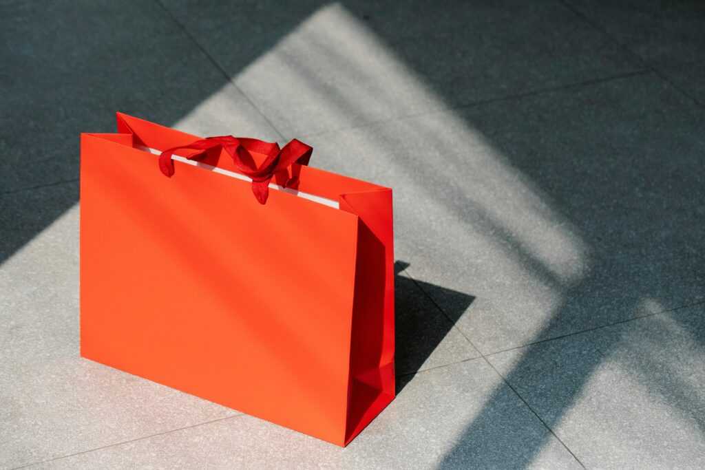 Red paper shopping bag on gray ground